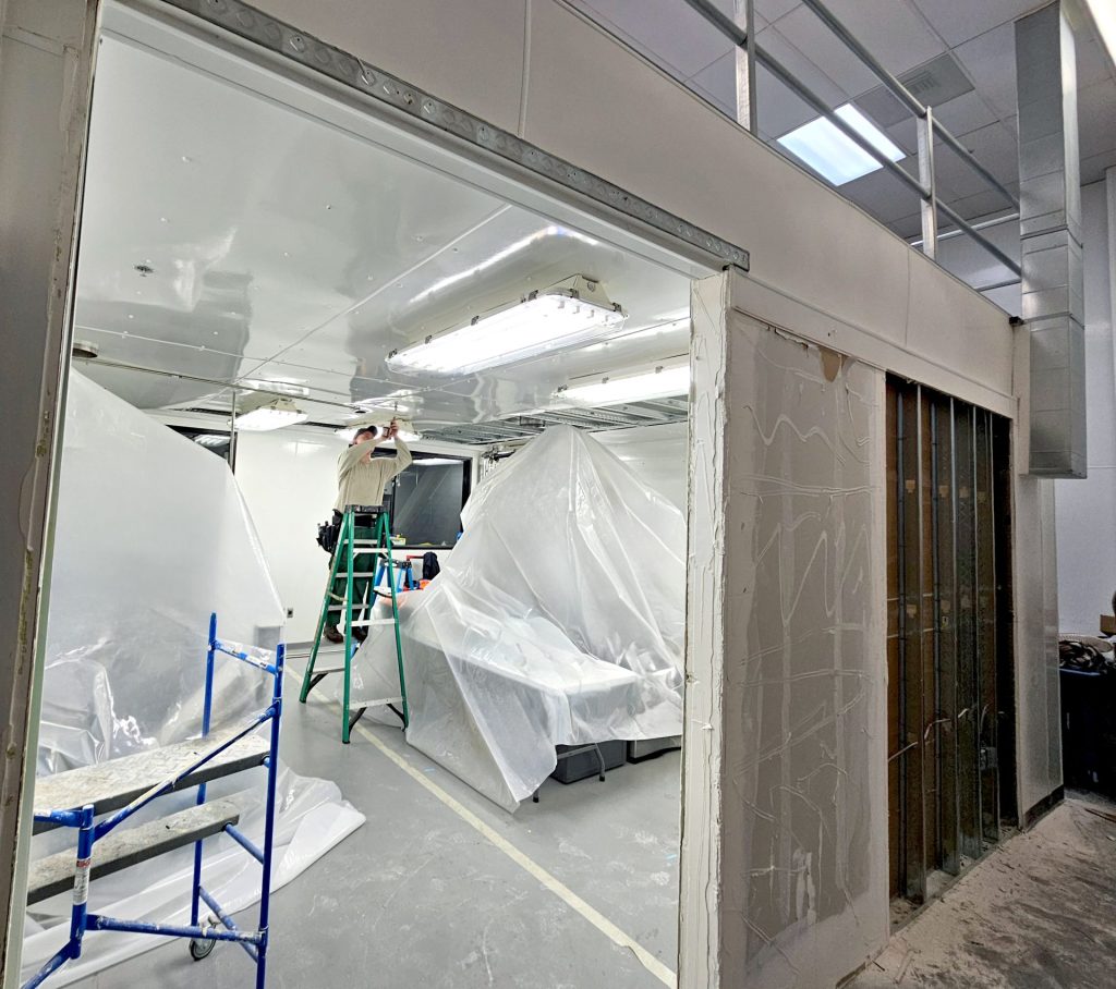 installing light fixtures in room underneath mezzanine