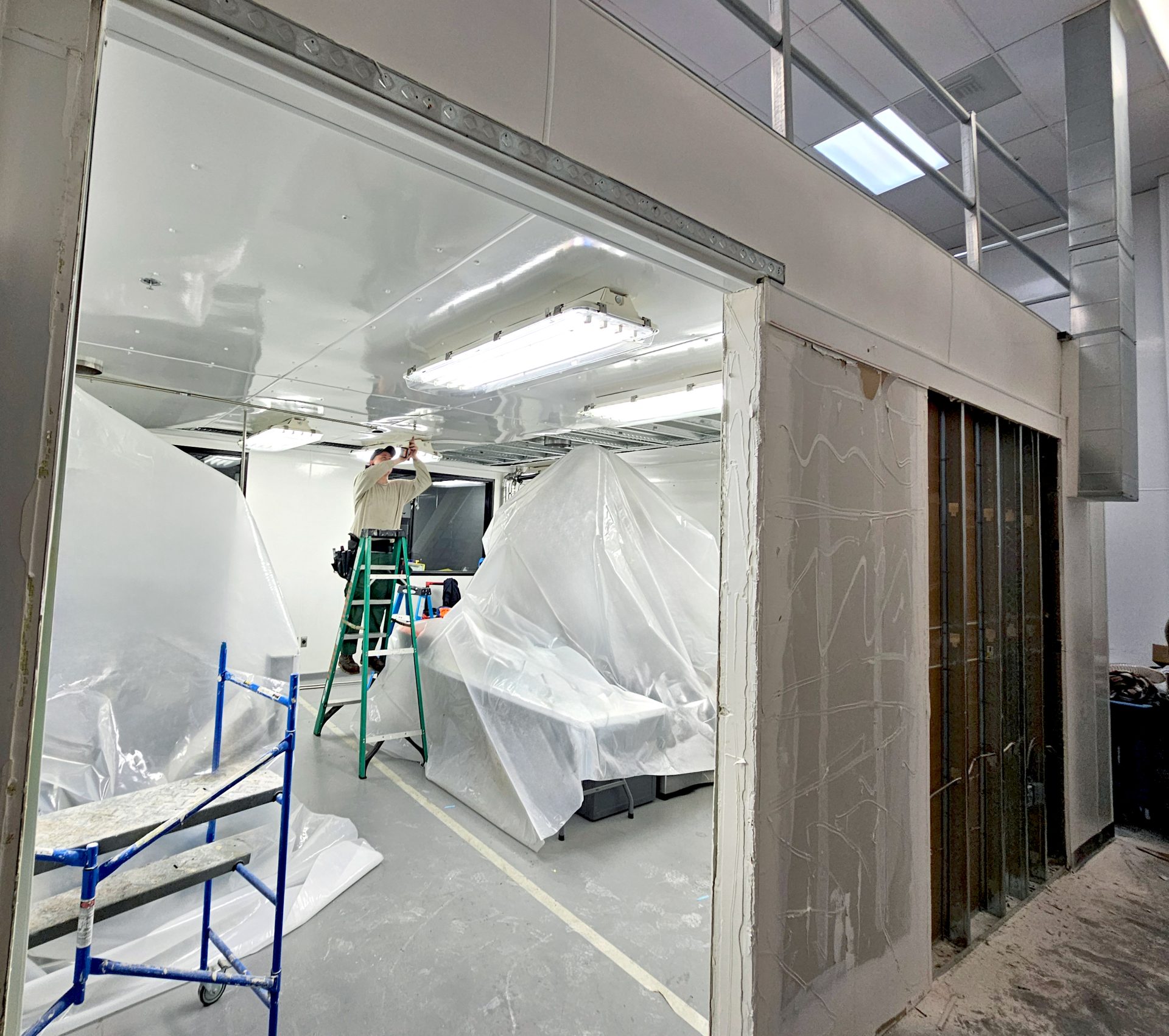 installing light fixtures in room underneath mezzanine