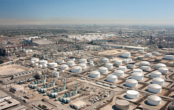 California in the background, wide aerial view of oil and gasoline storage and refinery.