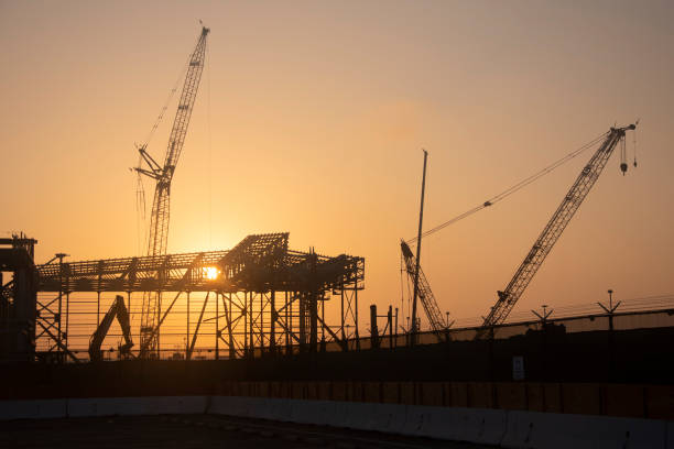 Steel frame of an airplane hangar being constructed at sunrise at LAX.
